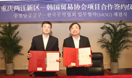 15일 중국 충칭시 량장신취관리원에서 개최된 '한국무역협회-량장신취관리위원회 온·오프라인 마케팅 협약식'에서 안현호 한국무역협회 상근부회장(오른쪽)과 탕린 량장신취관리위원회 부위원장이 협약 체결 후 기념촬영을 하고 있다.<한국무역협회 제공>